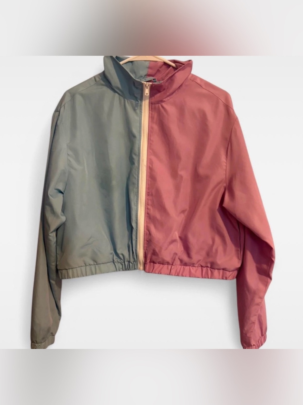 lightweight windbreaker jacket with a color-block design (blue and pink)